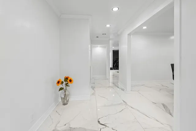 a view of a kitchen with refrigerator and a sink