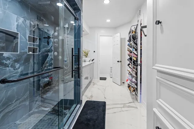 a bathroom with a glass shower door