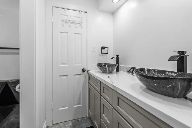 a patio with a table and chairs and a fire pit