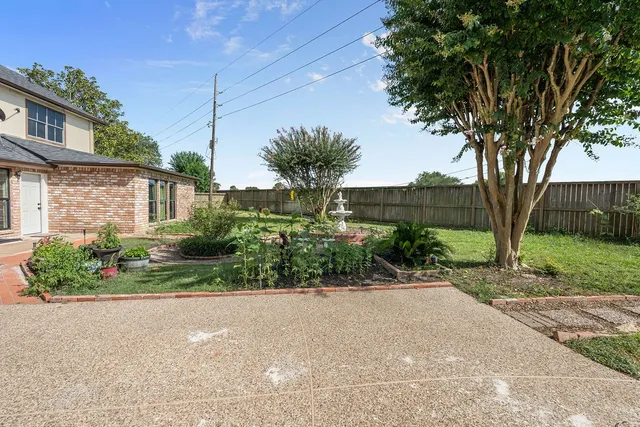a view of a backyard with swimming pool