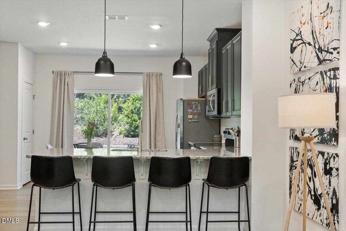 517 Hacksaw Trail Raleigh, NC 27610 - Photo 5 of 20 a view of open kitchen with dining table and chairs