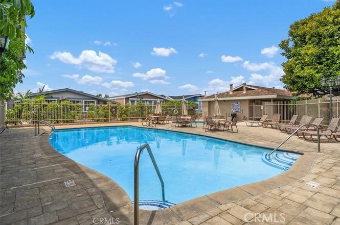 3050 West Ball Road, Unit 171 Anaheim, CA 92804 - Photo 14 of 15 a view of a swimming pool with a lounge chair