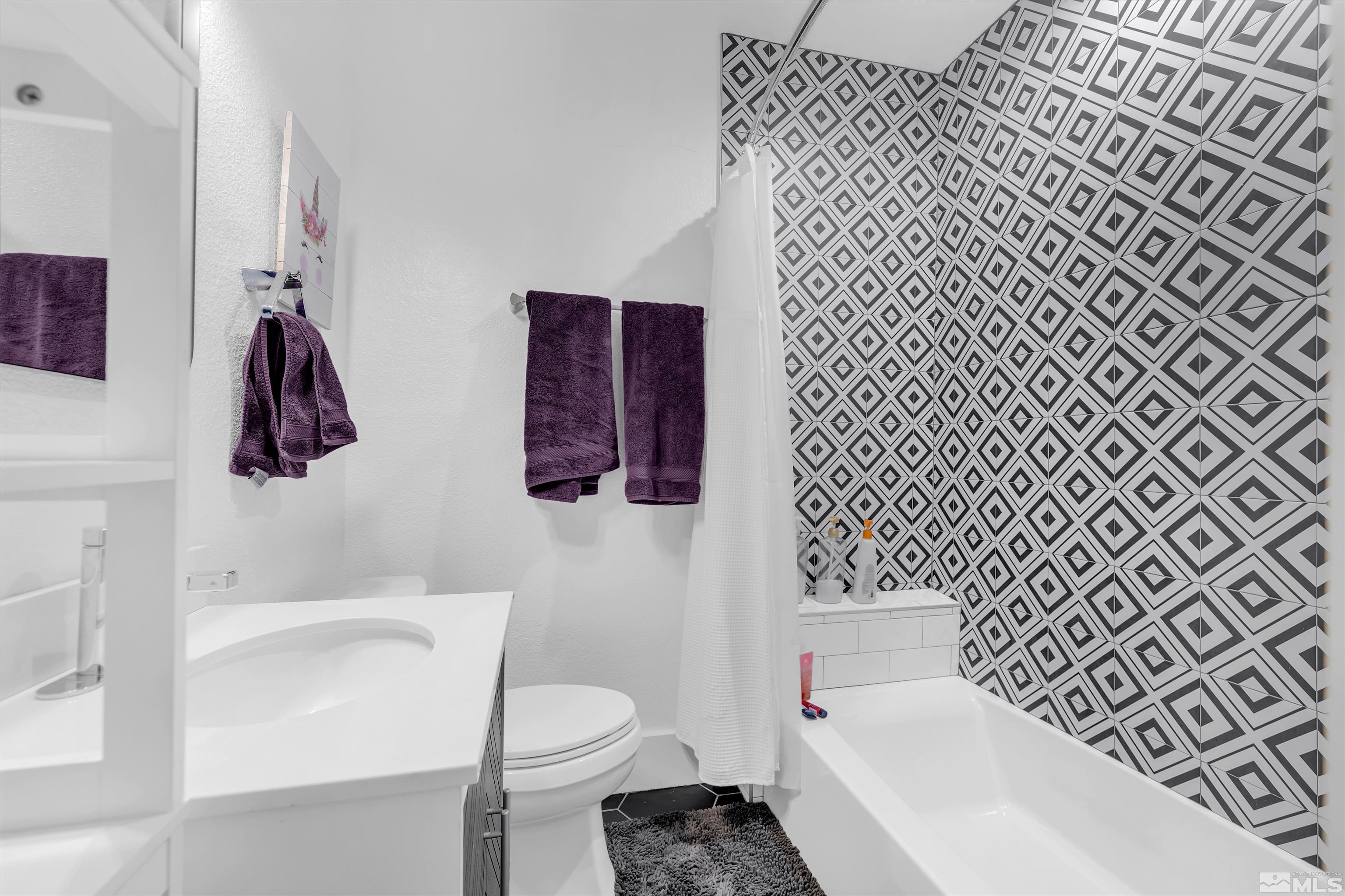 128 Stewart Street Reno, NV 89501 - Photo 15 of 24 a bathroom with a sink toilet and shower