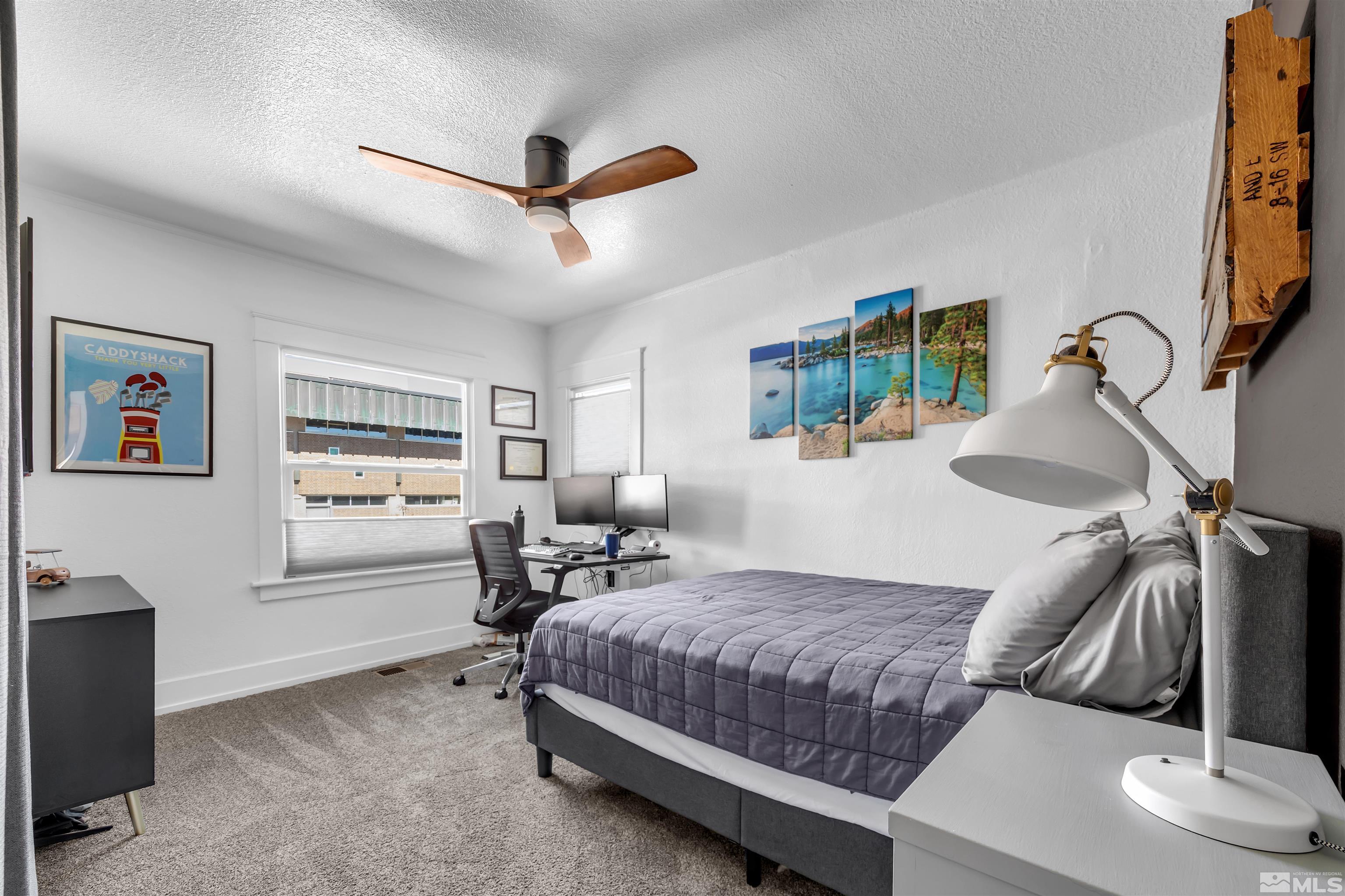 128 Stewart Street Reno, NV 89501 - Photo 19 of 24 a bedroom with a bed and wooden floor