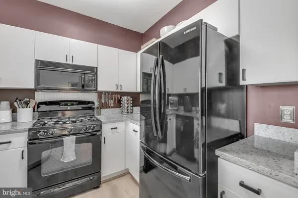 a kitchen with a refrigerator and counter