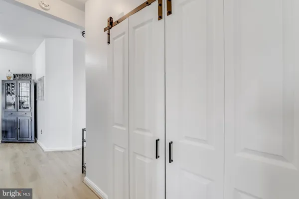 a spacious bedroom with a bed and a flat screen tv