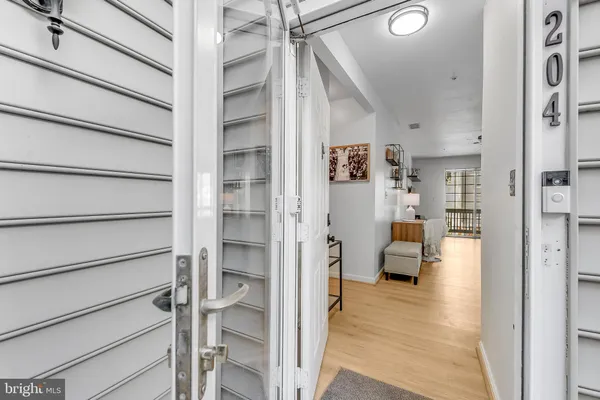 a view of a porch with furniture and wooden floor