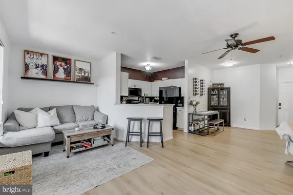 a living room with furniture and kitchen view