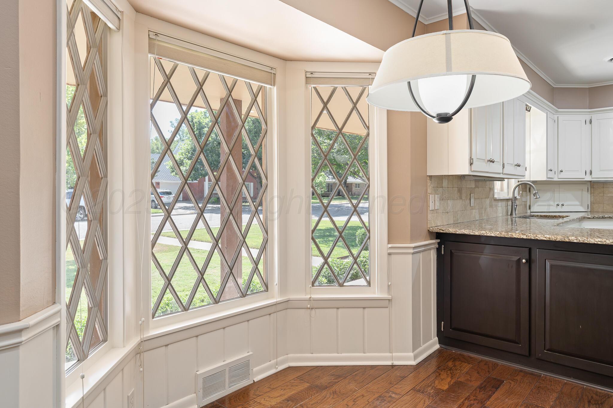 3804 Doris Drive Amarillo, TX 79109 - Photo 19 of 53 a kitchen with a window a sink and cabinets