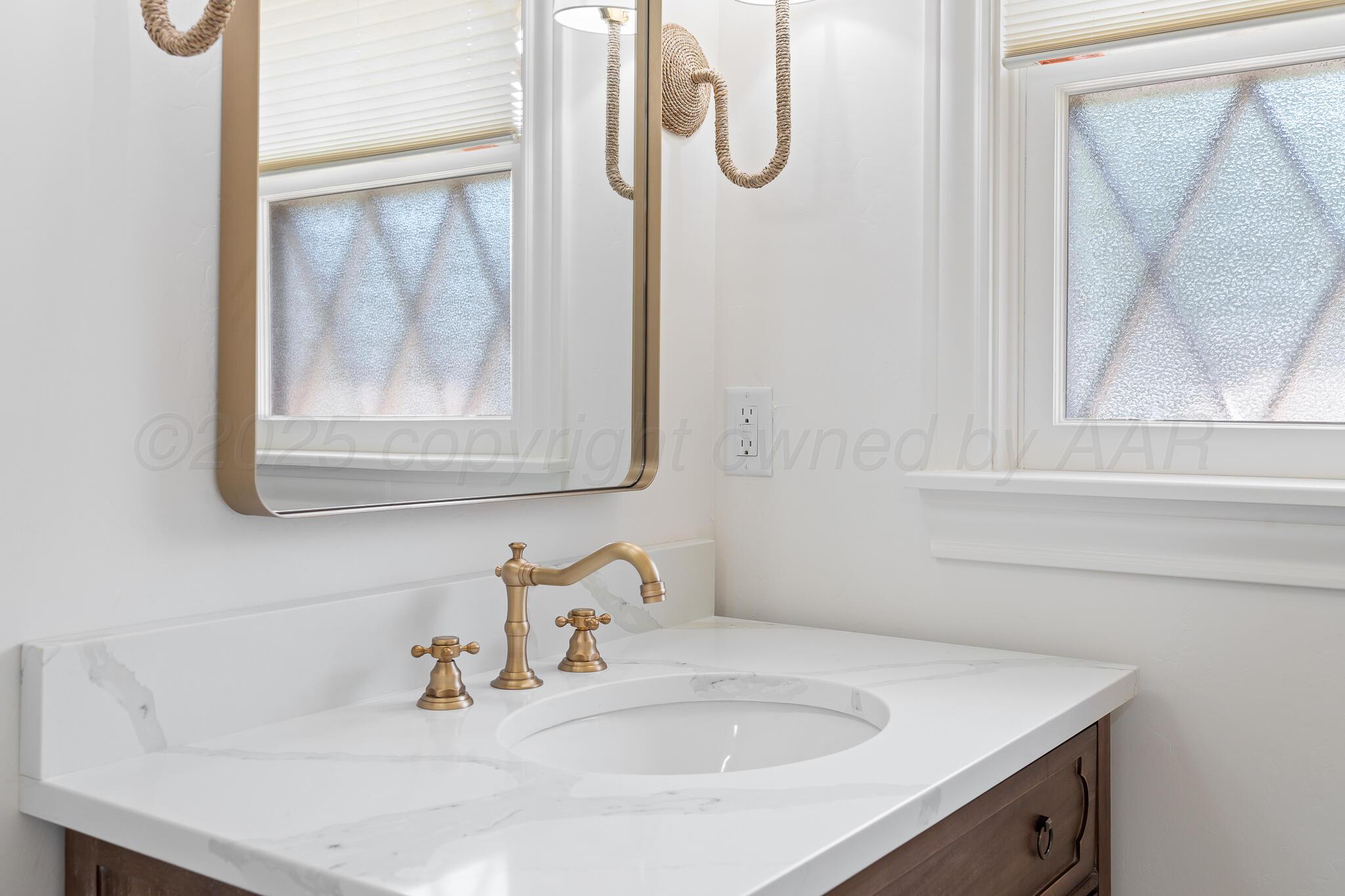 3804 Doris Drive Amarillo, TX 79109 - Photo 21 of 53 a bathroom with a sink and a mirror