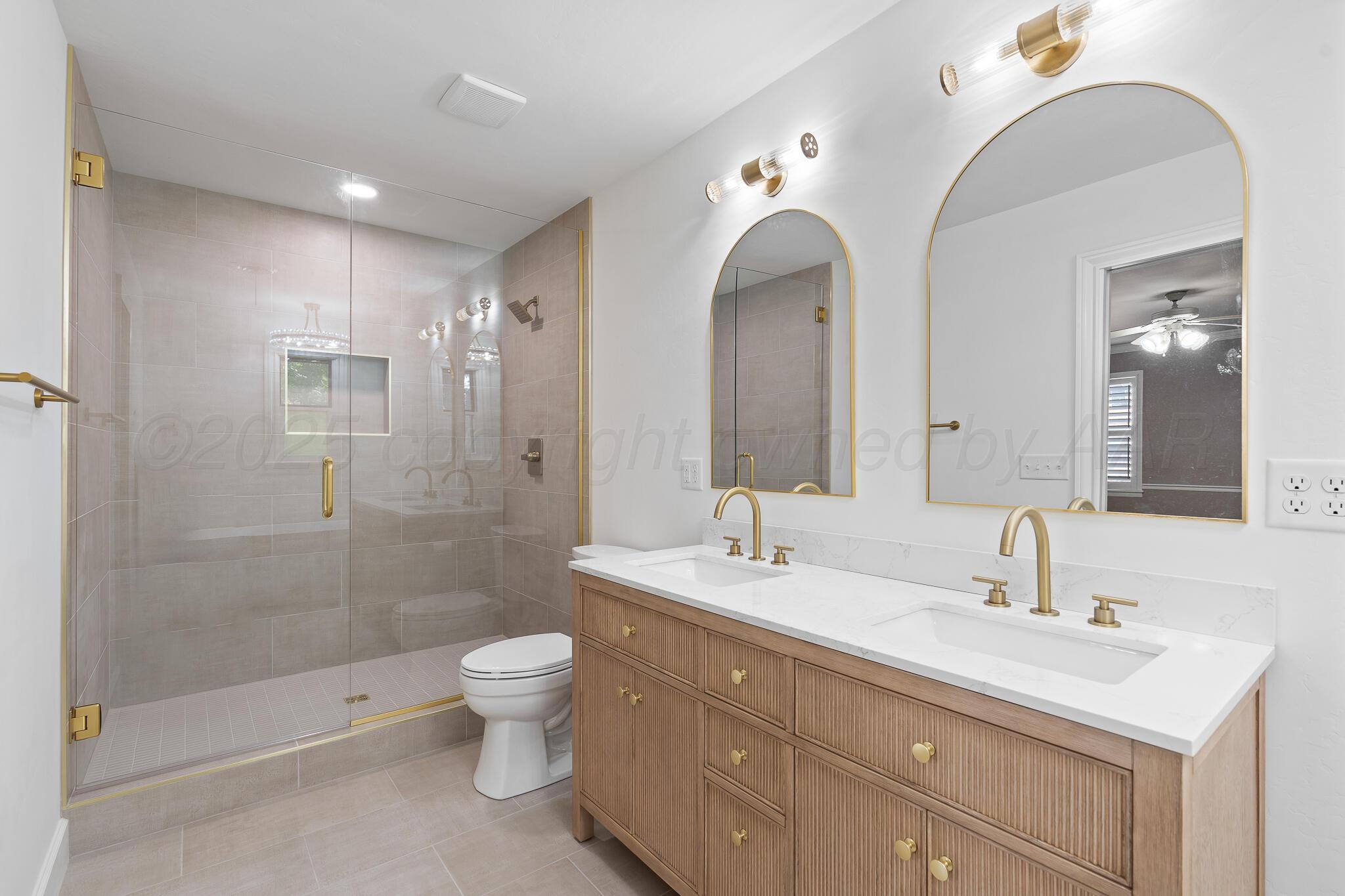 3804 Doris Drive Amarillo, TX 79109 - Photo 25 of 53 a bathroom with a double vanity sink toilet and shower