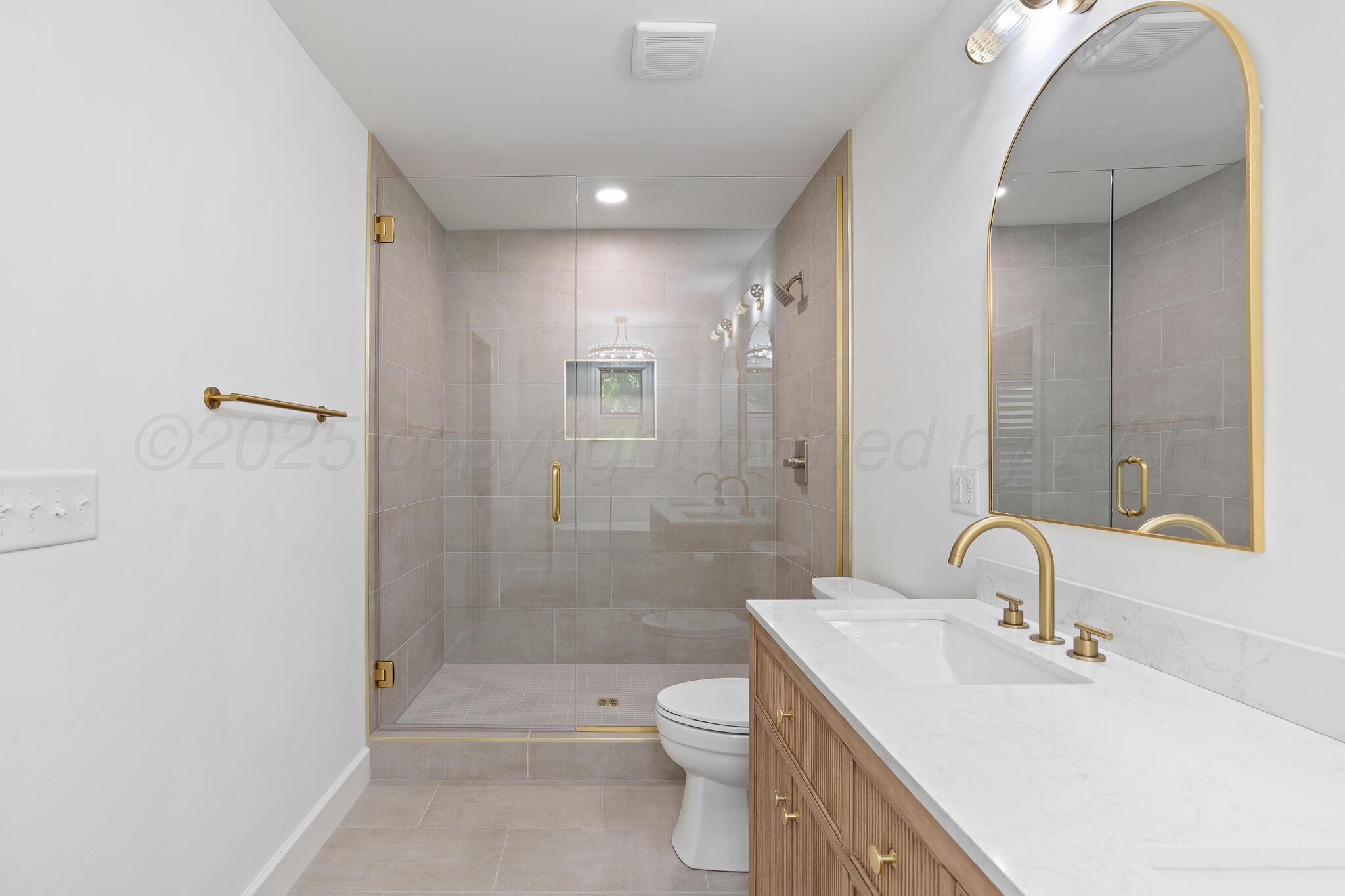 3804 Doris Drive Amarillo, TX 79109 - Photo 26 of 53 a bathroom with a double vanity sink toilet and shower
