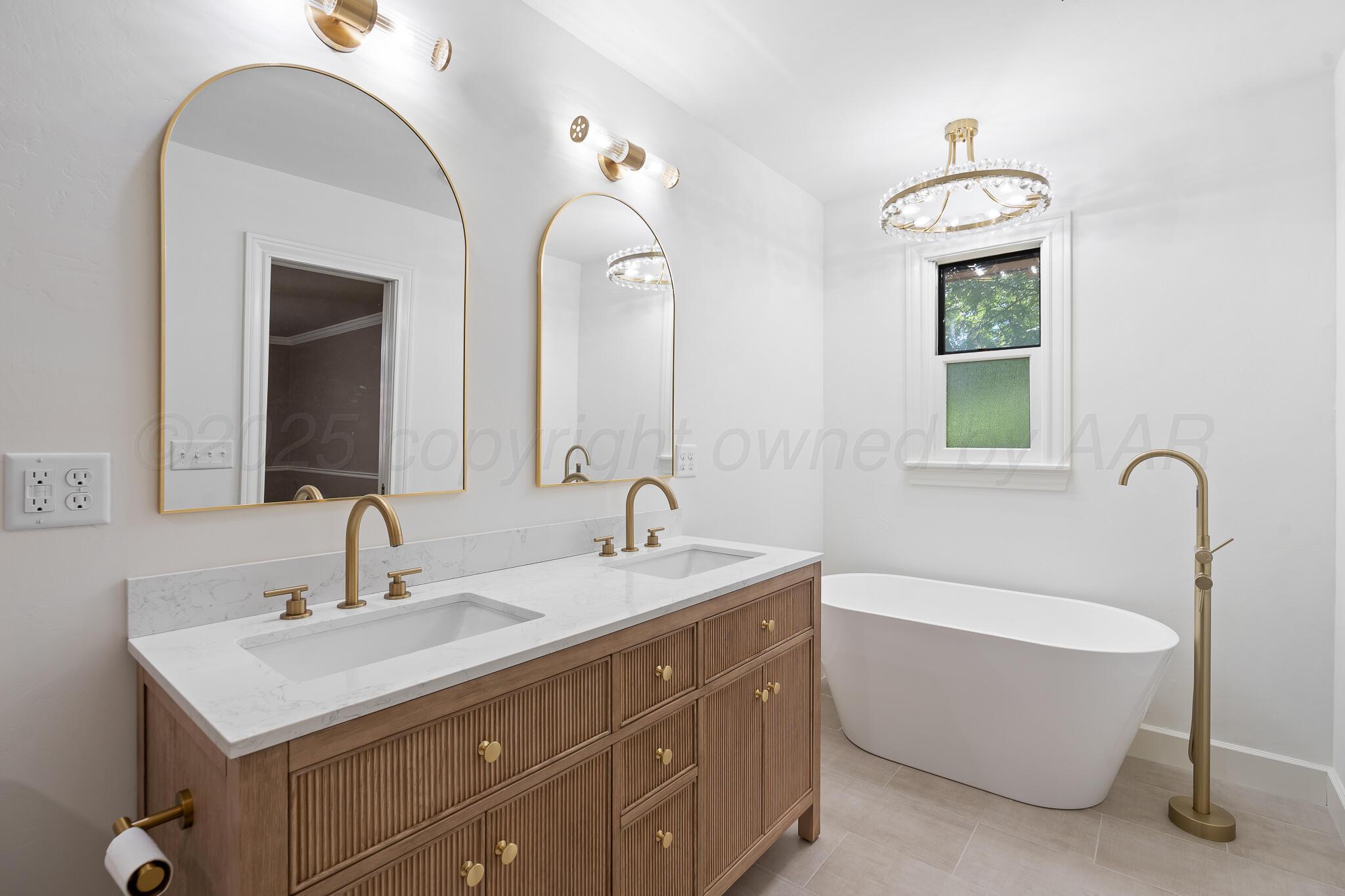 3804 Doris Drive Amarillo, TX 79109 - Photo 29 of 53 a bathroom with a double vanity sink mirror and bathtub