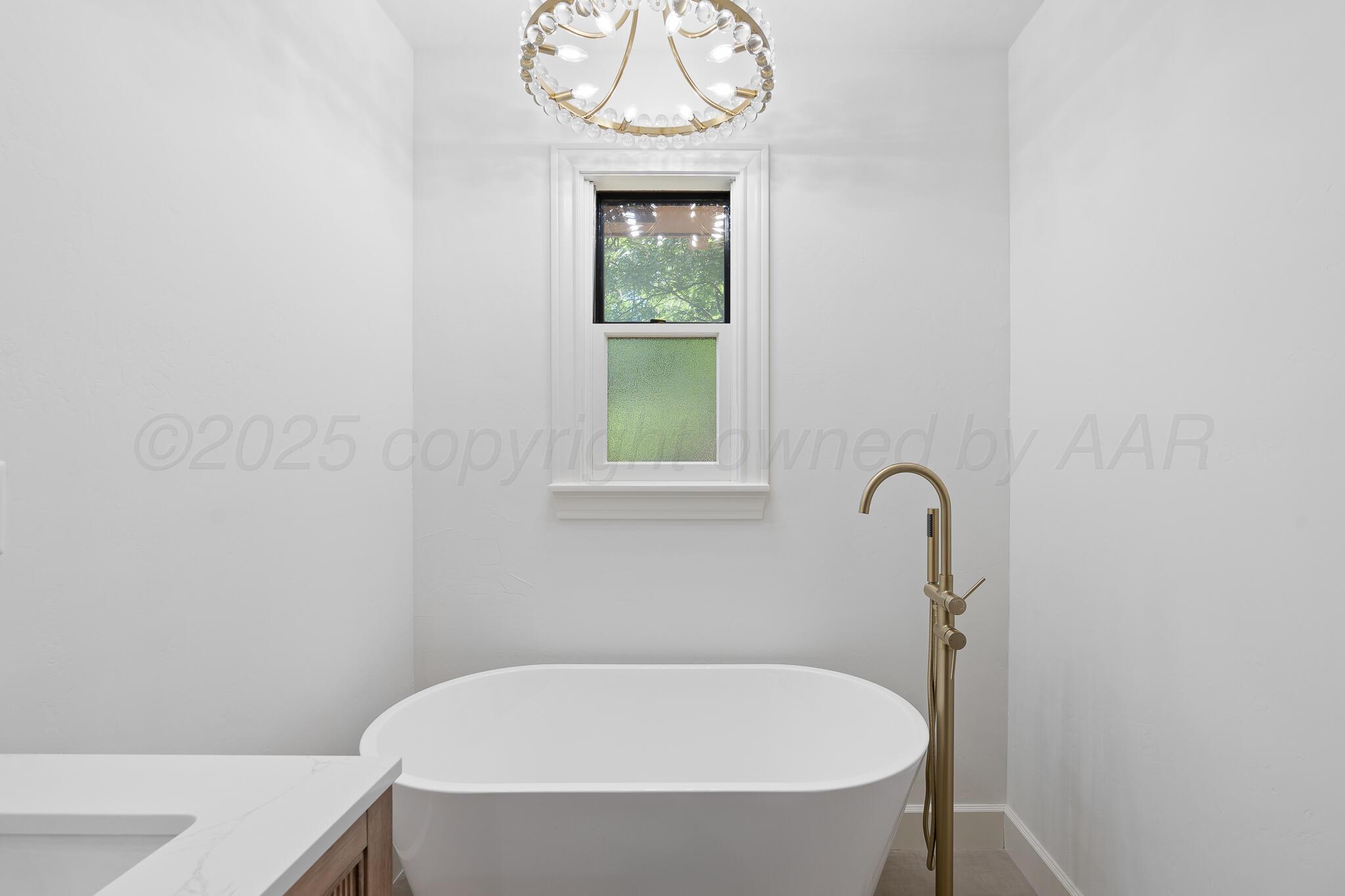 3804 Doris Drive Amarillo, TX 79109 - Photo 30 of 53 a white bath tub sitting in a bathroom