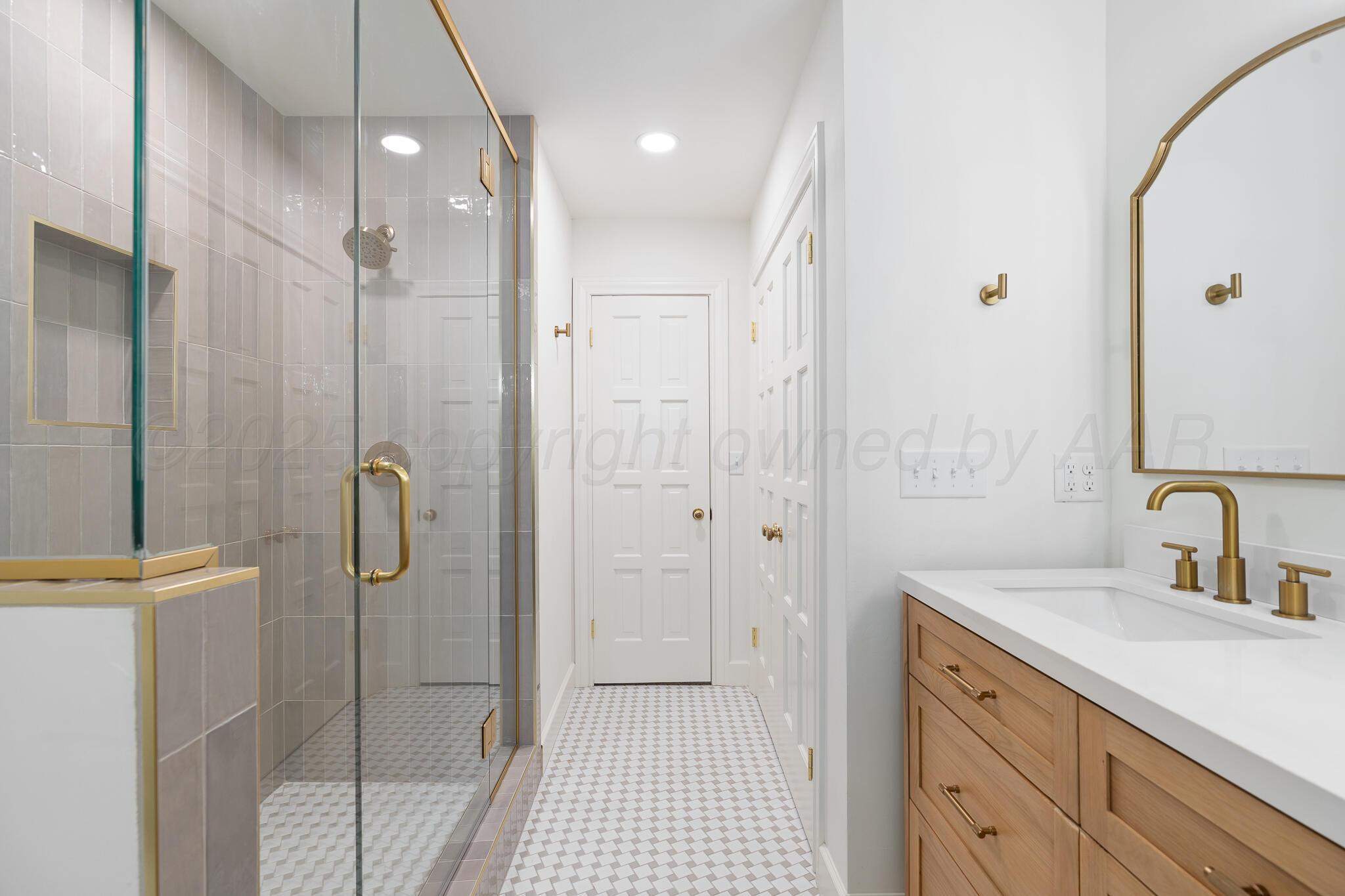 3804 Doris Drive Amarillo, TX 79109 - Photo 39 of 53 a bathroom with a shower sink and mirror