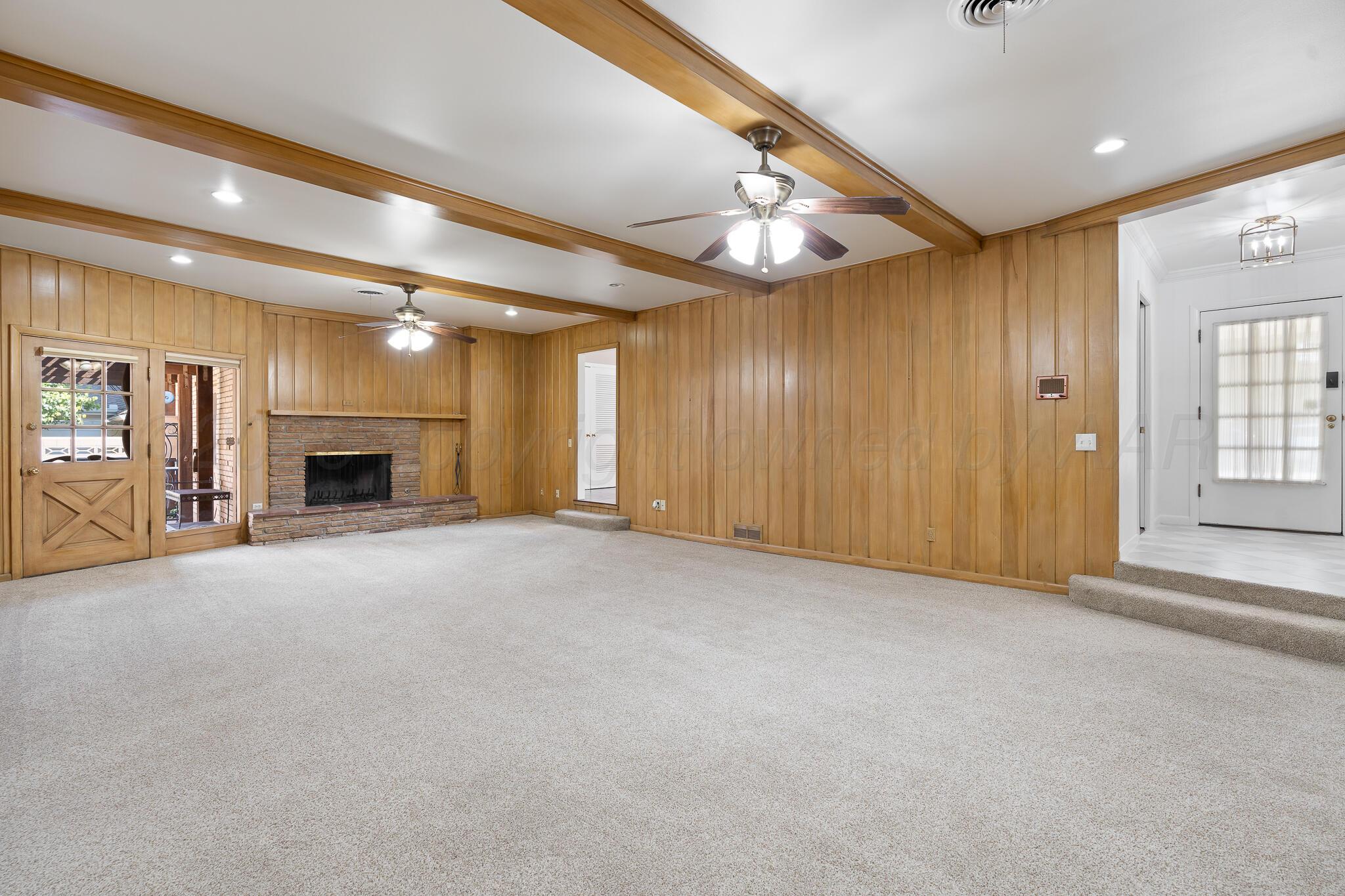 3804 Doris Drive Amarillo, TX 79109 - Photo 7 of 53 an empty room with fireplace and windows