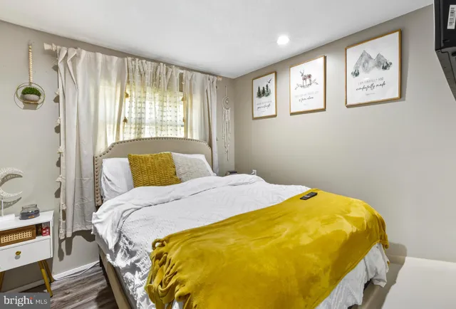 a bed sitting in a bedroom next to a window