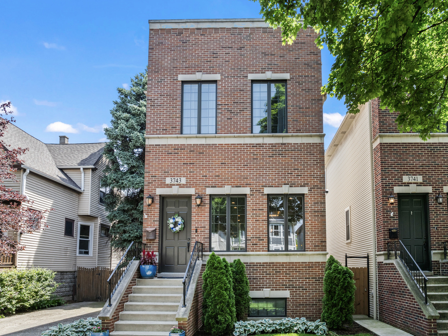 front view of a brick house with a yard