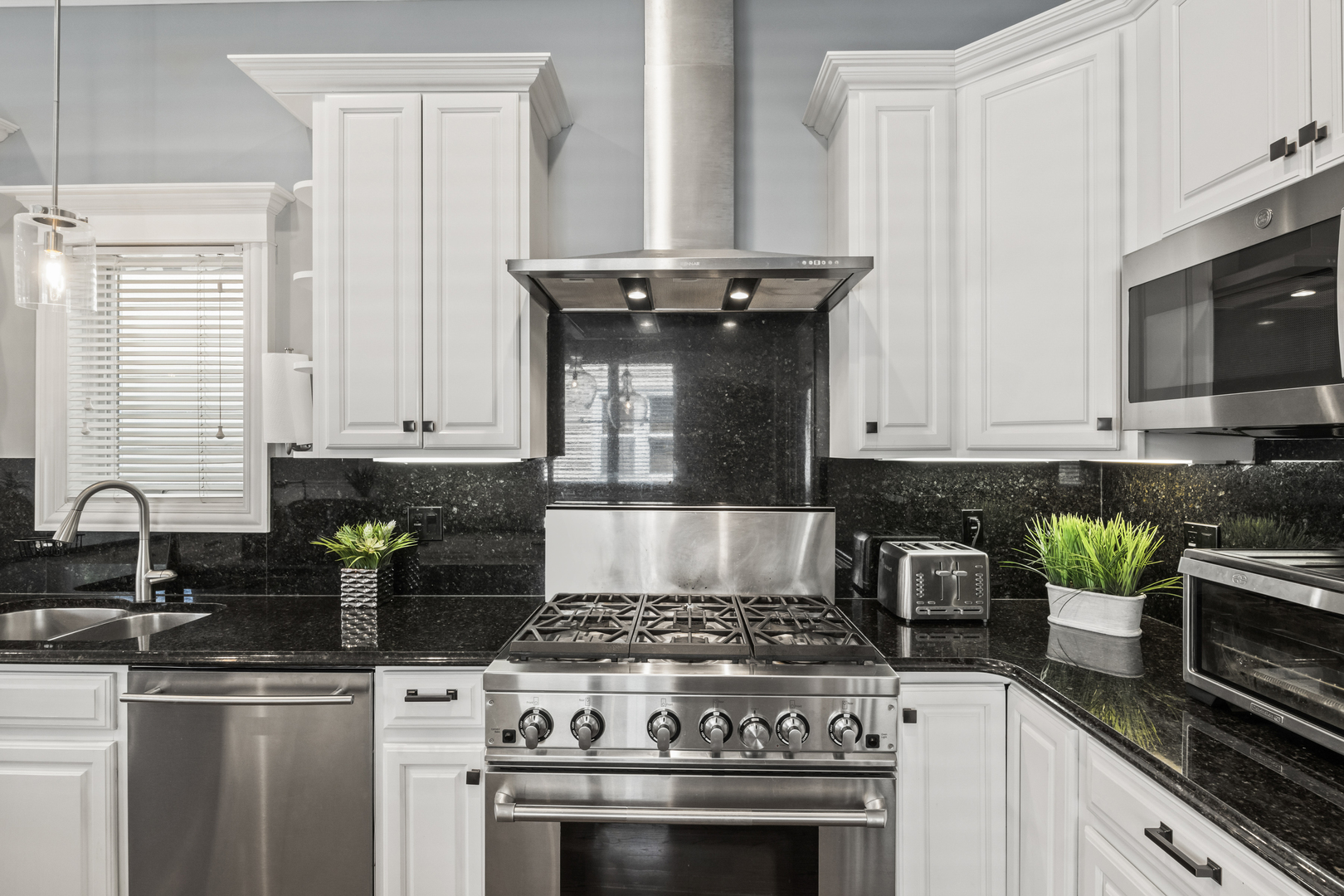 3743 North Ridgeway Avenue Chicago, IL 60618 - Photo 11 of 65 a kitchen with granite countertop a stove top oven a sink a counter space and cabinets