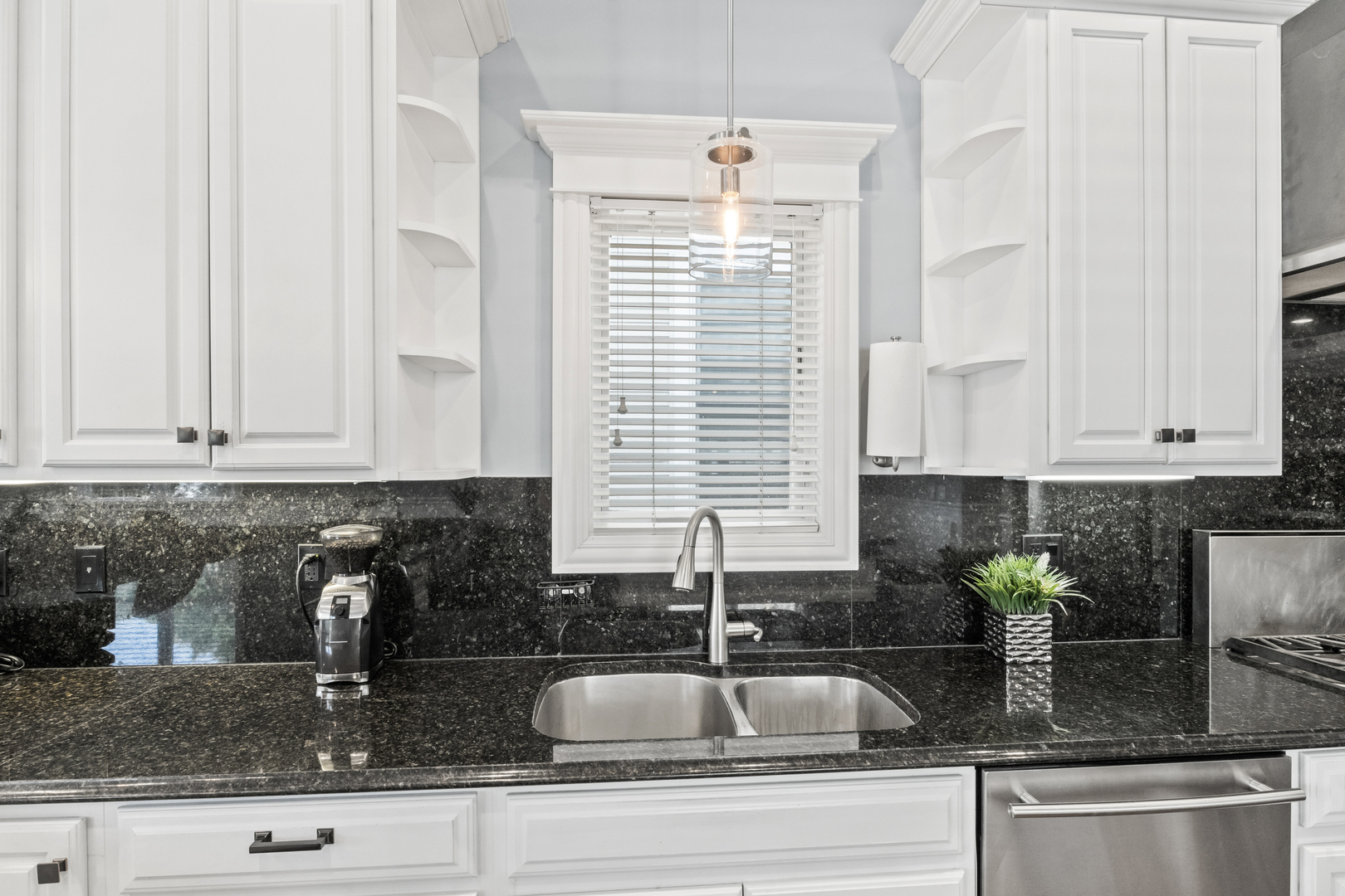 3743 North Ridgeway Avenue Chicago, IL 60618 - Photo 12 of 65 a kitchen with granite countertop a sink white cabinets and window