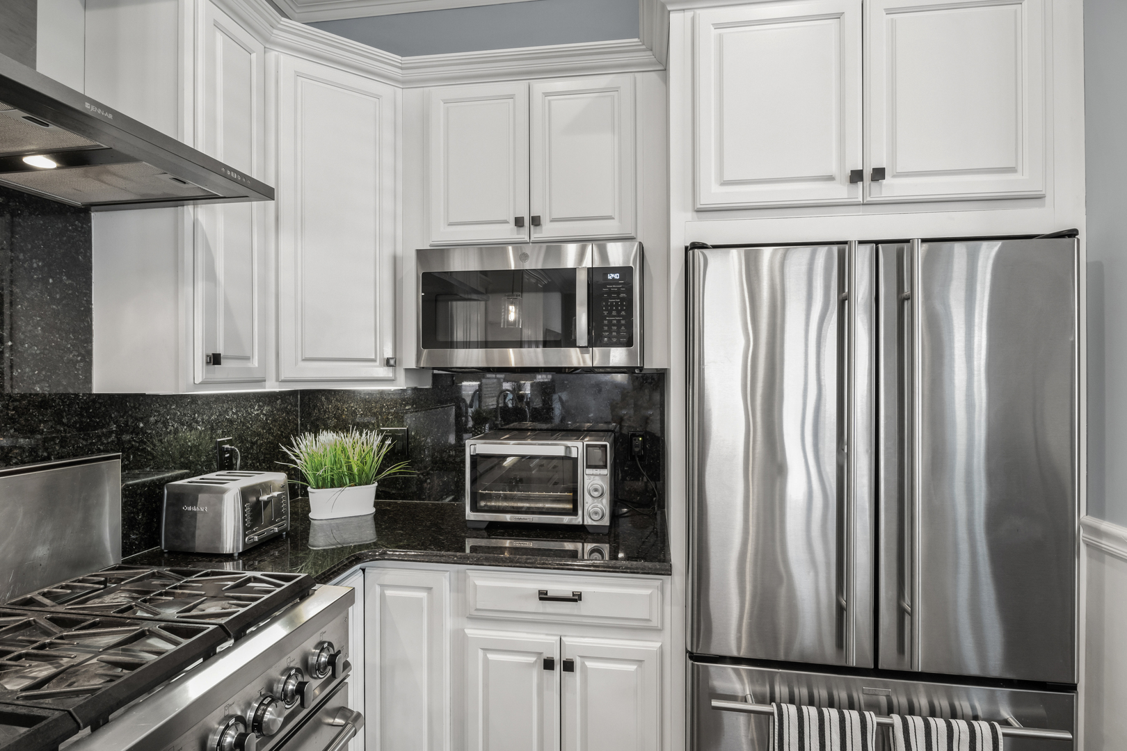 3743 North Ridgeway Avenue Chicago, IL 60618 - Photo 13 of 65 a kitchen with granite countertop a stove and a refrigerator
