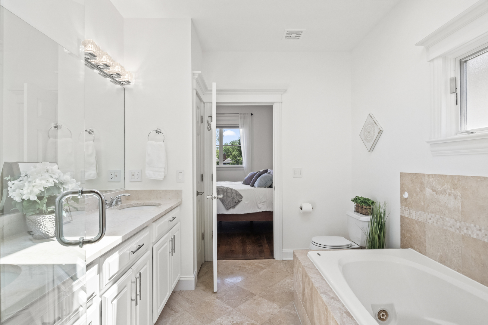 3743 North Ridgeway Avenue Chicago, IL 60618 - Photo 31 of 65 a en suite bathroom with a granite countertop tub and a sink