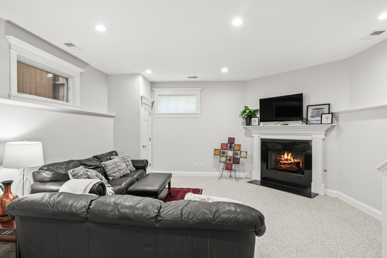 3743 North Ridgeway Avenue Chicago, IL 60618 - Photo 40 of 65 a living room with furniture a fireplace and a flat screen tv
