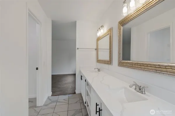 a spacious bathroom with a bathtub sink and mirror