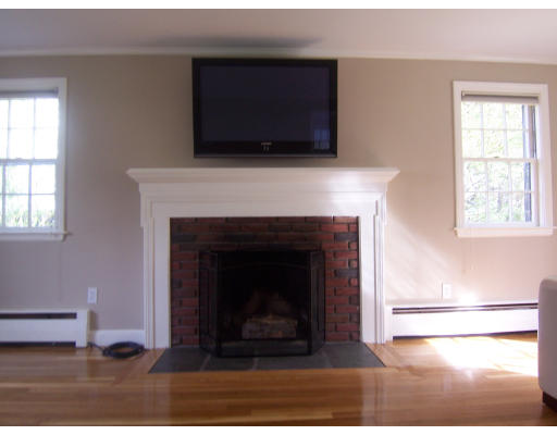 38 Governors Road Milton, MA 02186 - Photo 6 of 15 a living room with a fireplace and a flat screen tv