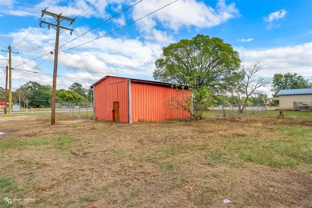 a view of backyard and wooden fence