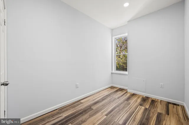a view of room with window and hardwood floor