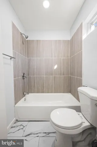 a bathroom with a toilet and a bathtub