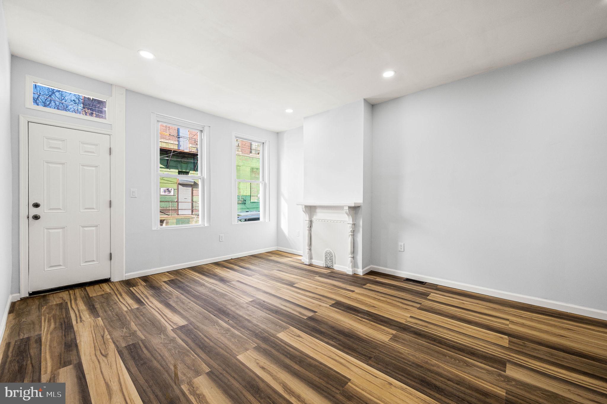 2139 North 10th Street Philadelphia, PA 19122 - Photo 5 of 20 a view of an empty room with wooden floor and a window