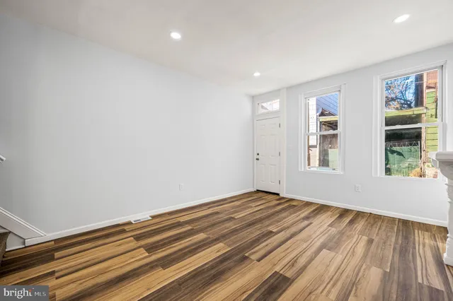 a view of room with window and wooden floor