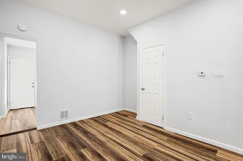 a view of a room with wooden floor and closet