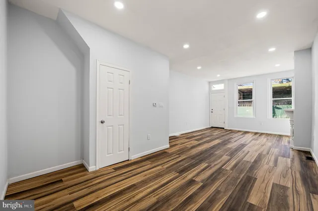 a view of an empty room and wooden floor