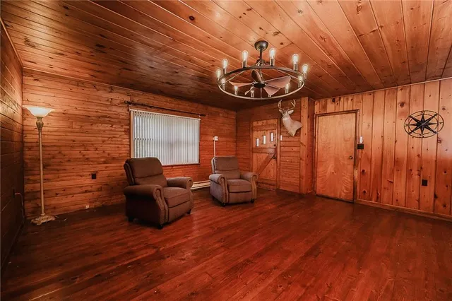 a living room with furniture a window and wooden floor