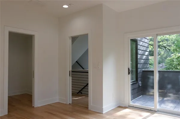 a view of entryway and hall with wooden floor