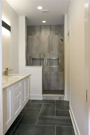 a bathroom with a shower and a sink