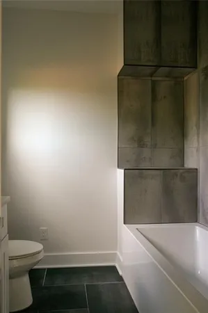 a bathroom with a bathtub and toilet