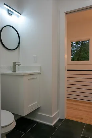a bathroom with a toilet and a mirror