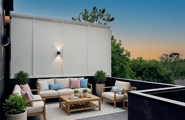 a outdoor living room with furniture and a potted plant