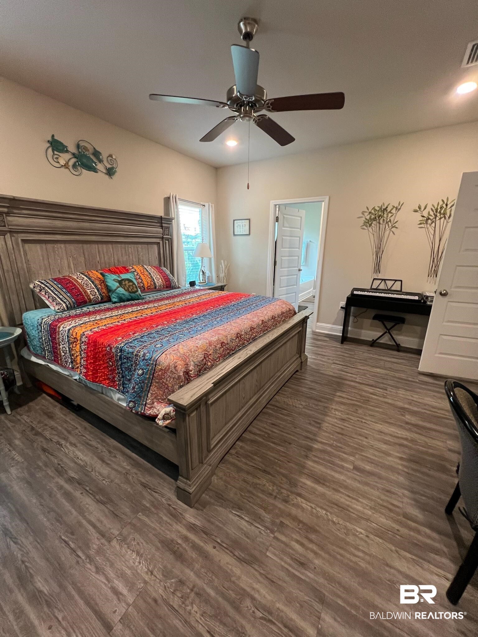 3904 Conrad Court Gulf Shores, AL 36542 - Photo 13 of 24 Bedroom with ceiling fan, ensuite bath, and dark wood-type flooring