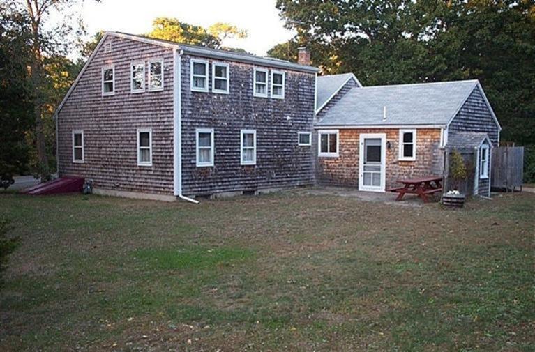 315 Samoset Road Eastham, MA 02642 - Photo 5 of 28 front view of a house with a yard