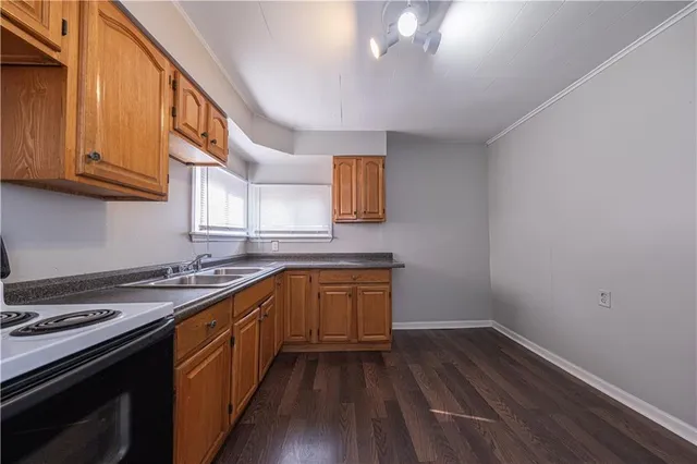 a kitchen with a sink stove and cabinets