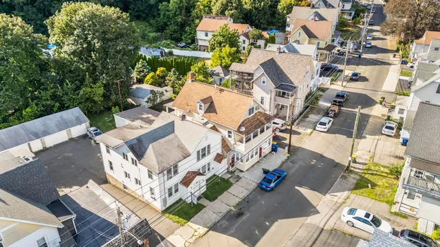 an aerial view of a house with a yard basket ball court and outdoor seating