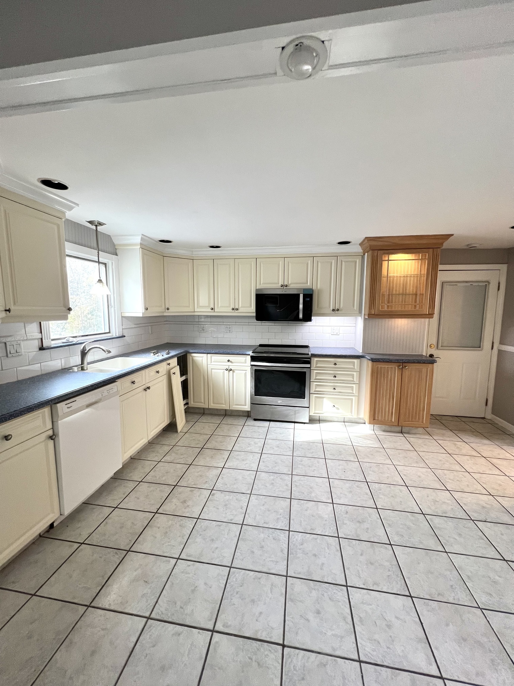 121 North State Street Ansonia, CT 06401 - Photo 19 of 37 a kitchen with a sink a stove and white cabinets