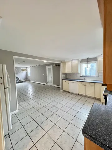 a view of an empty room and wooden floor