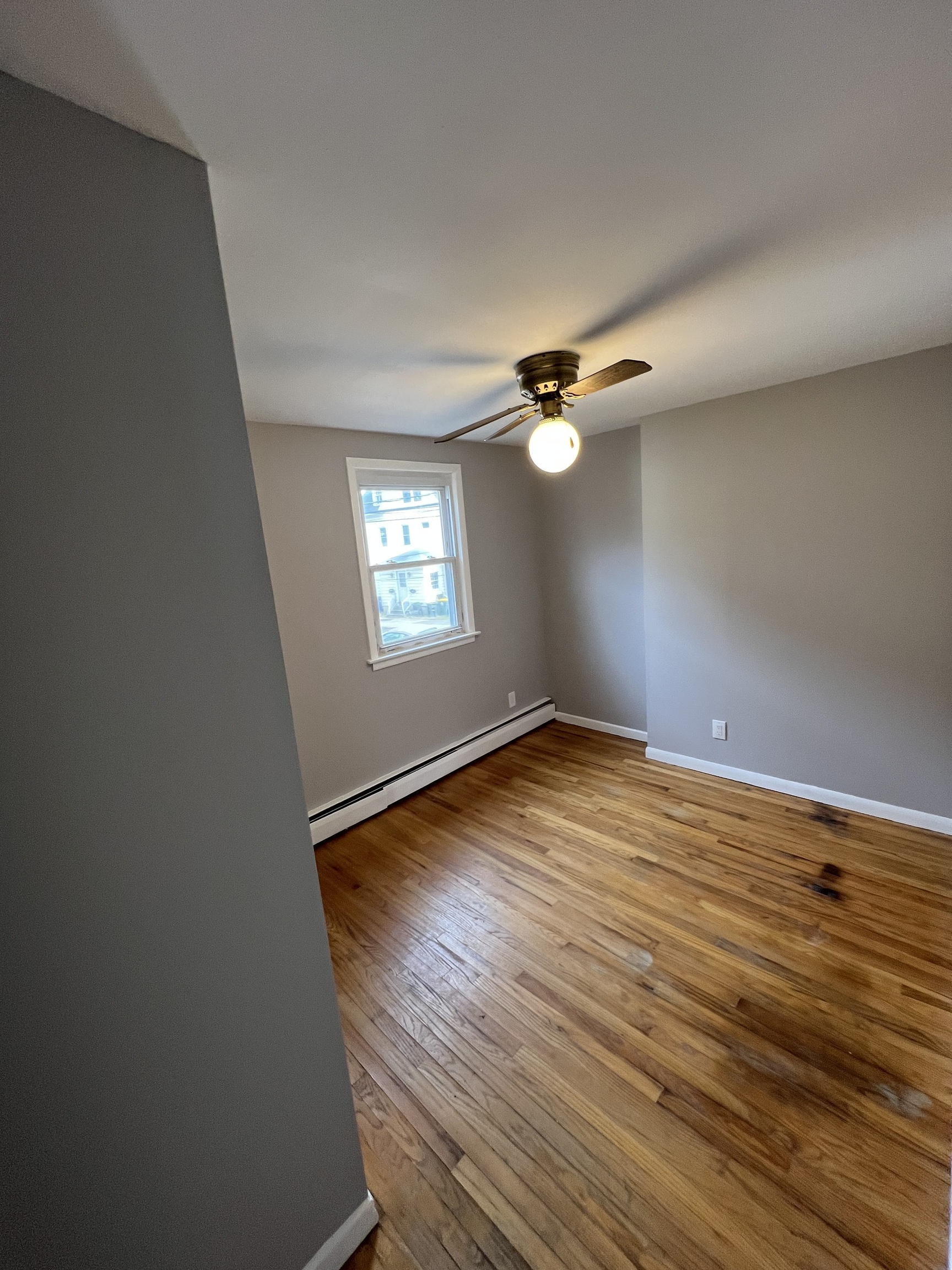121 North State Street Ansonia, CT 06401 - Photo 24 of 37 an empty room with wooden floor fan and windows