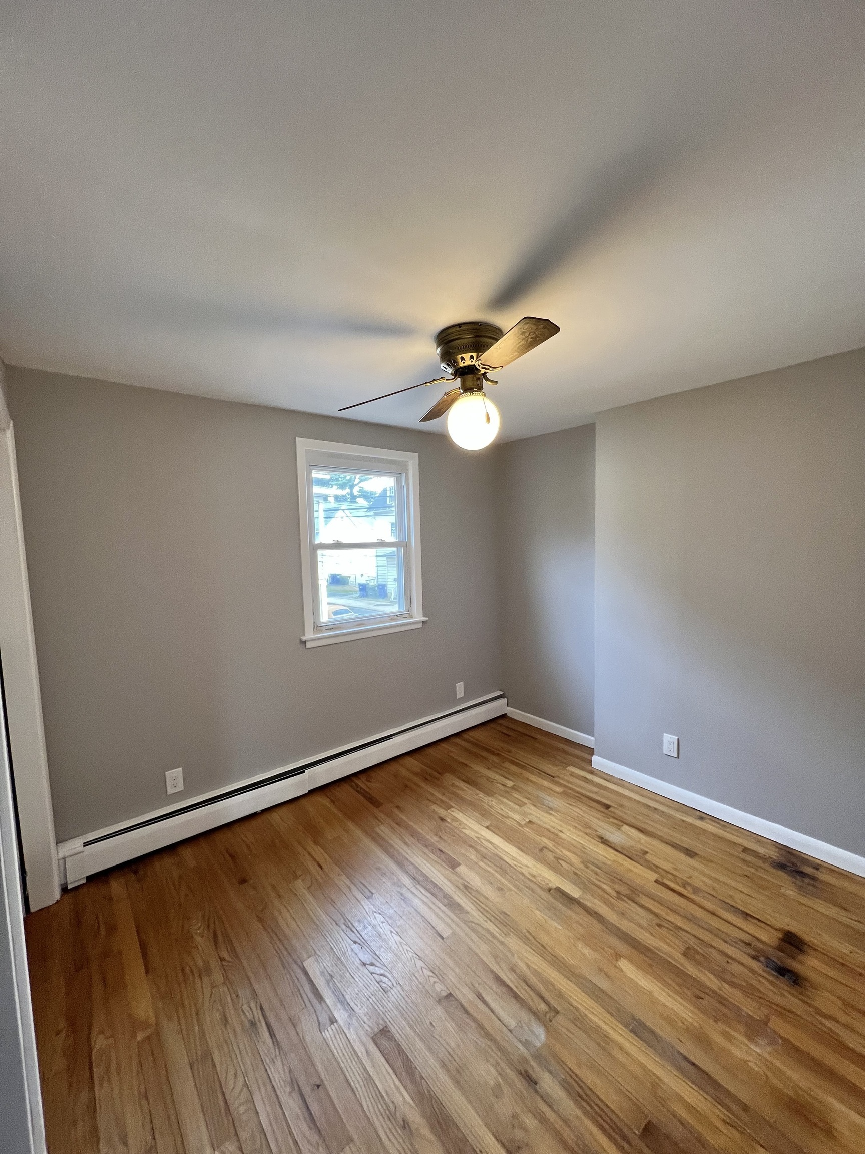121 North State Street Ansonia, CT 06401 - Photo 25 of 37 an empty room with wooden floor fan and windows